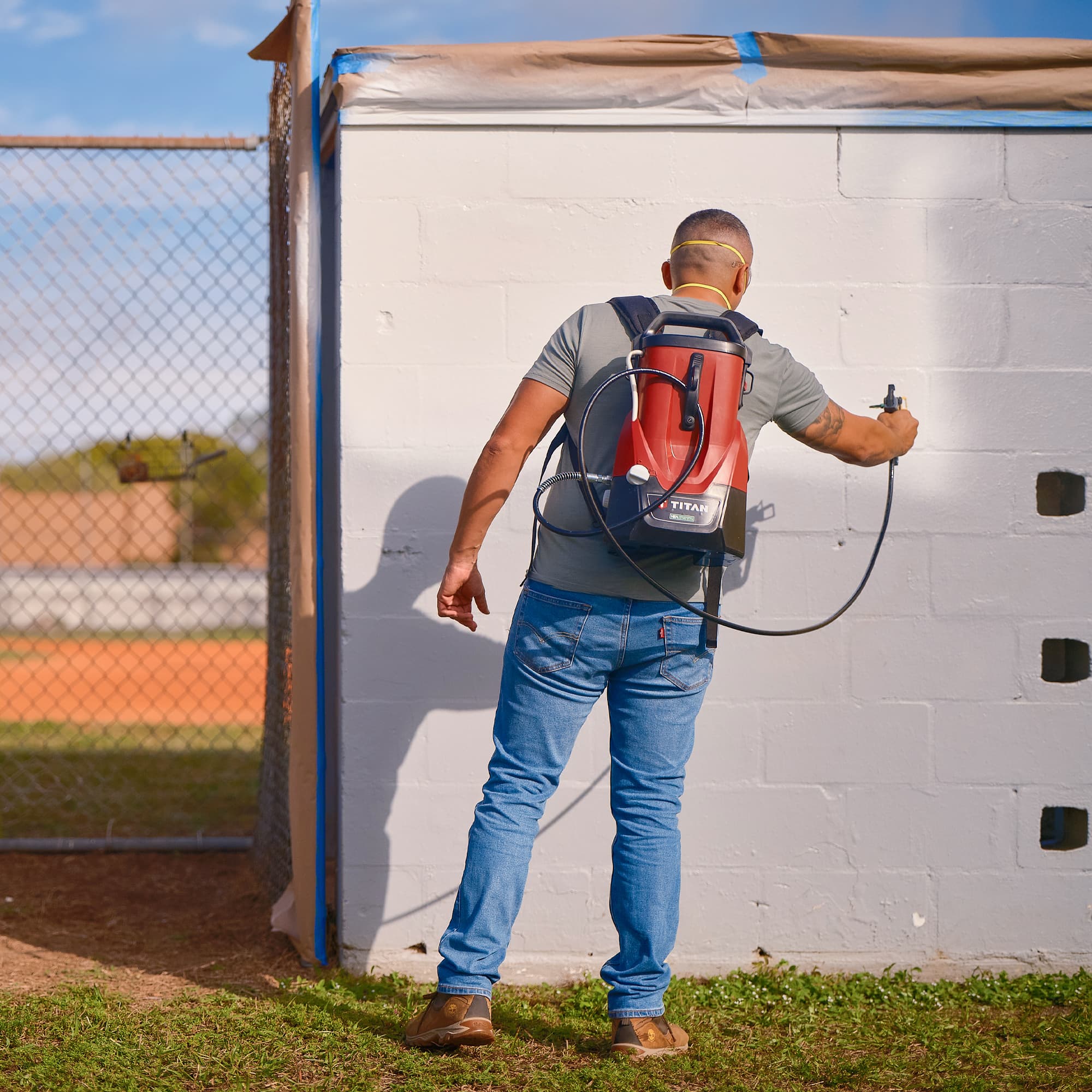 Image of man using Titan ControlMax Sprayer